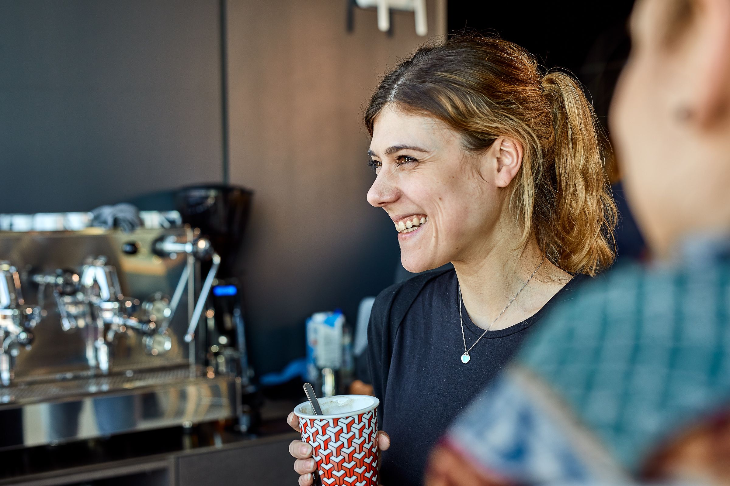 Woman having a coffee break at St. Gallen Merkle Office 
